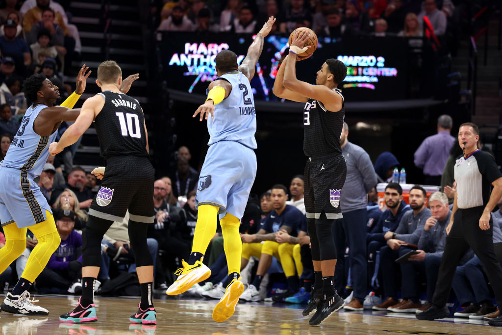 Keegan Murray #13 of the Sacramento Kings shoots a three-point basket over Xavier Tillman #2 of the...