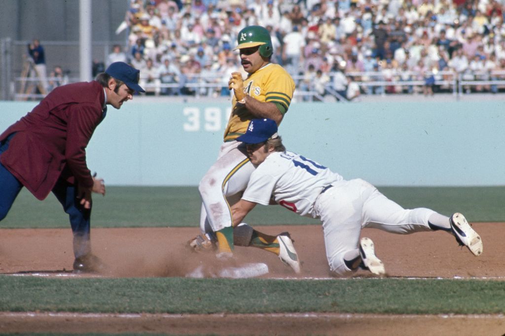 Sal Bando #6 of the Oakland Athletics is safe at second as Ron Cey #10 of the Los Angeles Dodgers t...