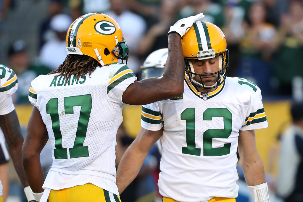 Davante Adams #17 congratulates Aaron Rodgers #12 of the Green Bay Packers after scoring a two-poin...
