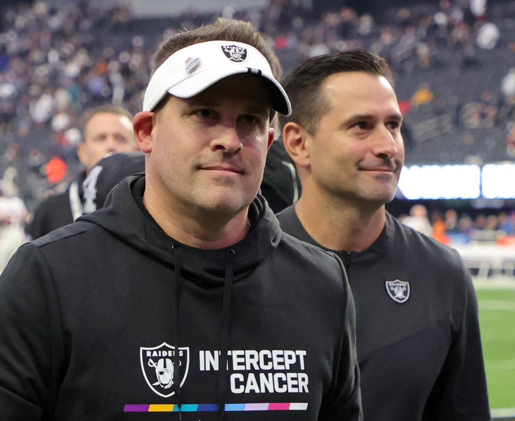 Head coach Josh McDaniels (L) and general manager Dave Ziegler of the Las Vegas Raiders walk off th...