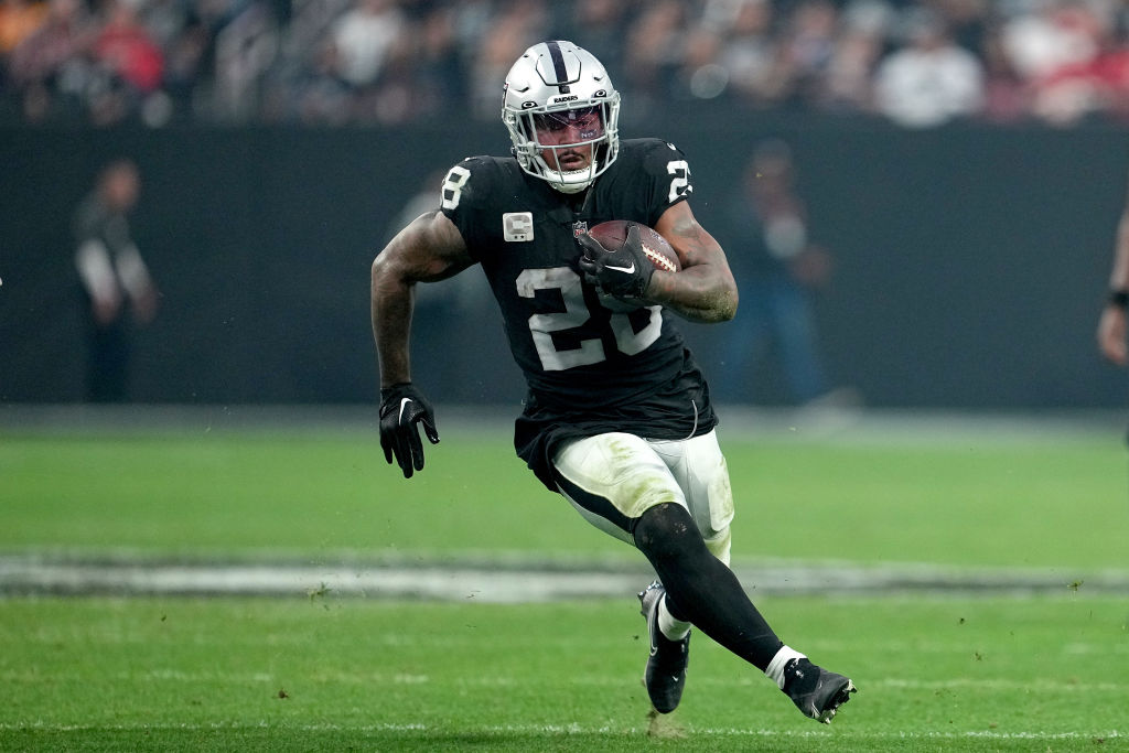 Josh Jacobs #28 of the Las Vegas Raiders carries the ball against the Kansas City Chiefs during the...