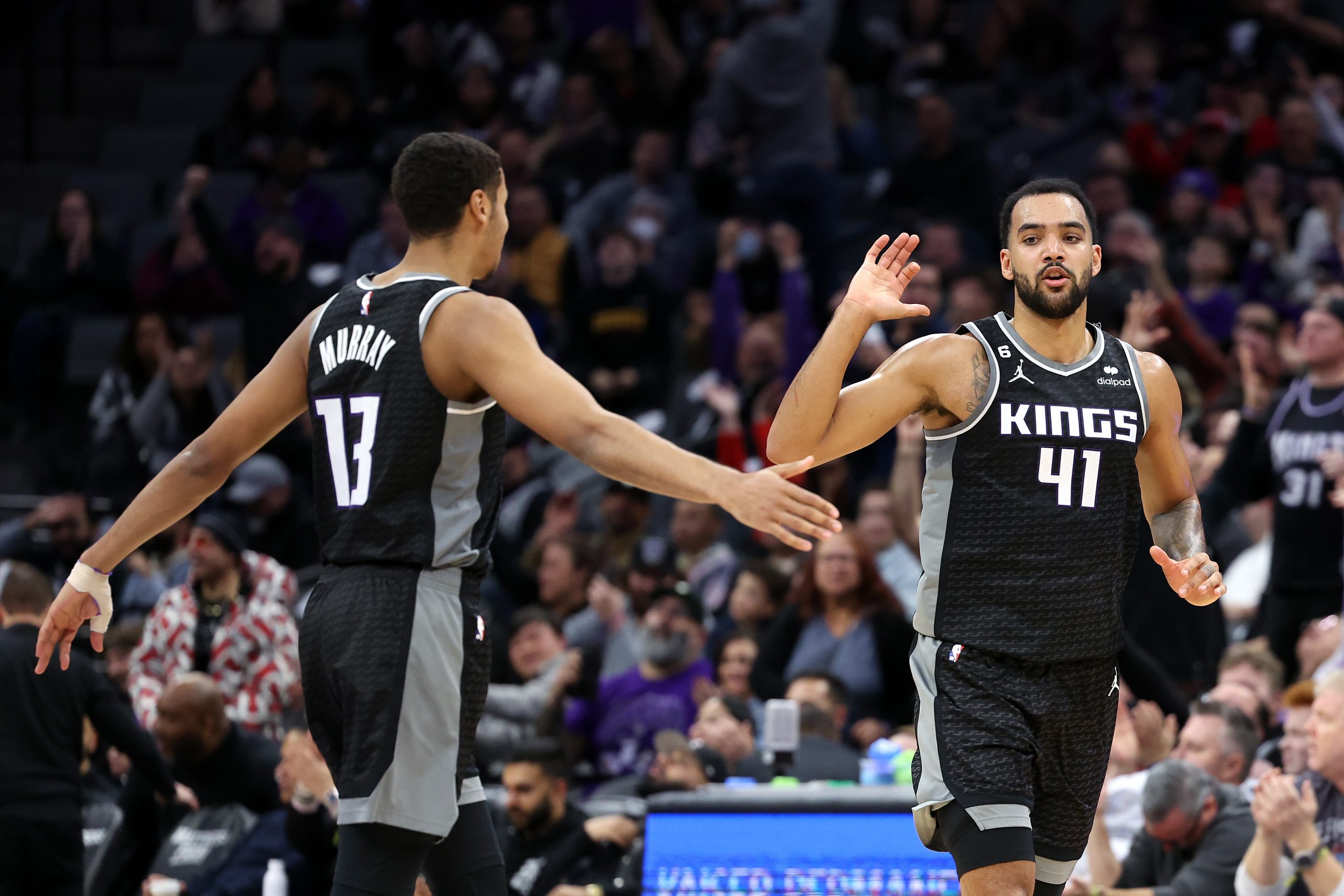 Keegan Murray #13 and Trey Lyles #41 of the Sacramento Kings react after Lyles made a three-point b...