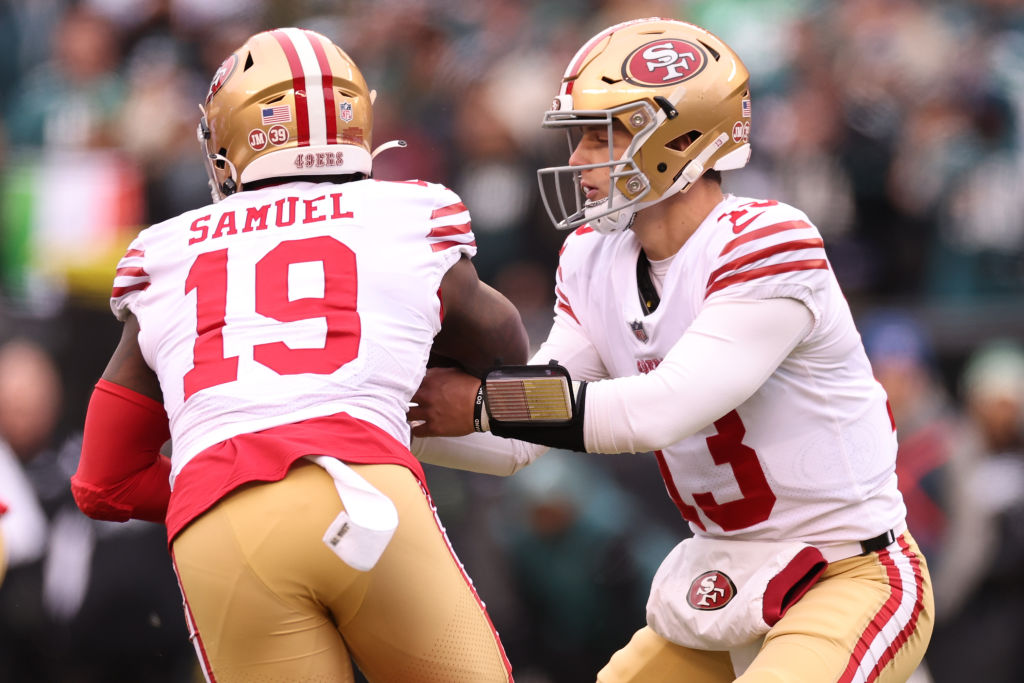 Brock Purdy #13 of the San Francisco 49ers hands the ball off to Deebo Samuel #19 against the Phila...