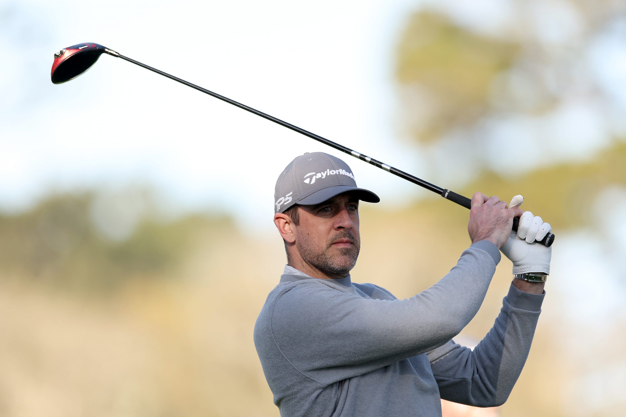NFL quarterback Aaron Rodgers tees off on the second hole prior to the AT&T Pebble Beach Pro-Am...