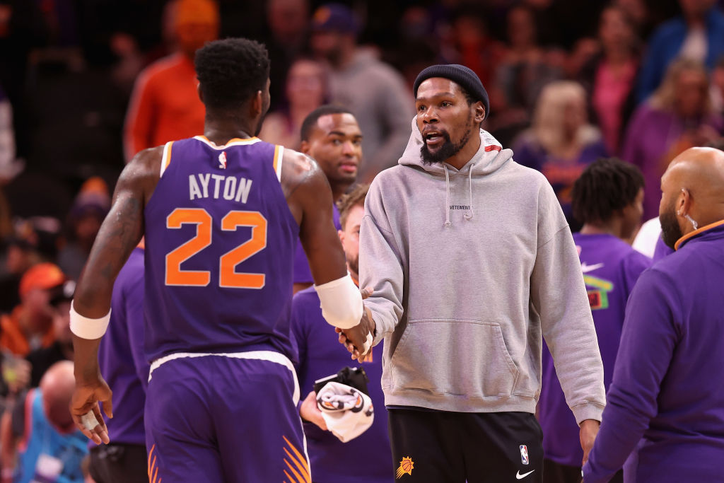 Kevin Durant #35 of the Phoenix Suns high fives Deandre Ayton #22 after scoring against the Sacrame...