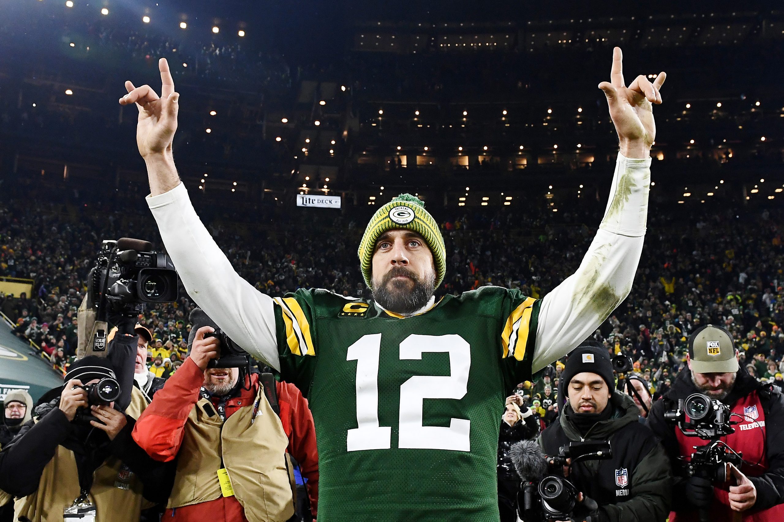 Aaron Rodgers #12 of the Green Bay Packers celebrates after defeating the Seattle Seahawks 28-23 in...