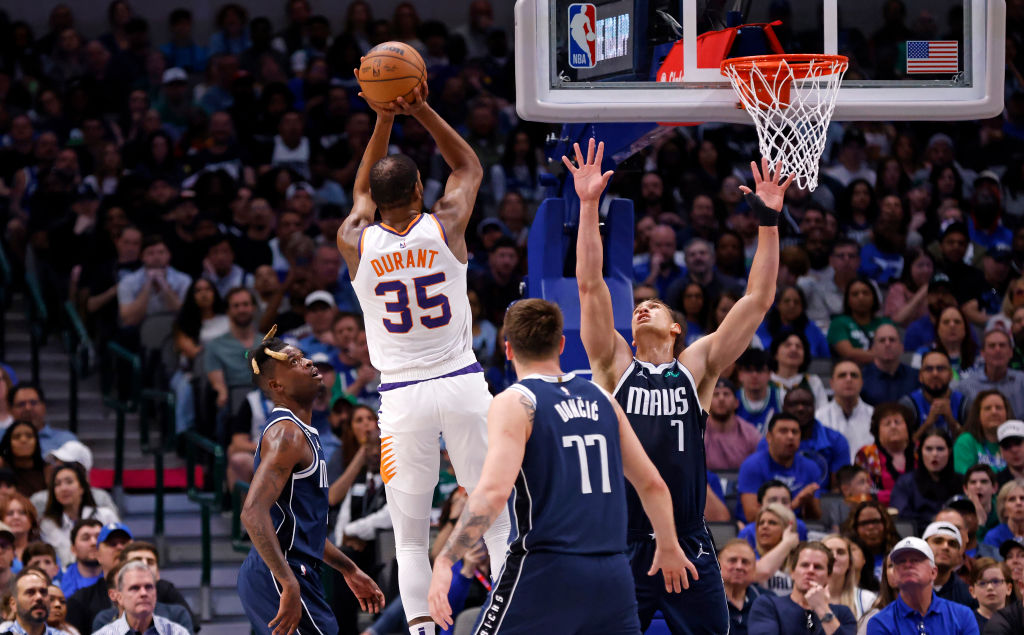 NBA star Kevin Durant #35 of the Phoenix Suns scores a basket against the Dallas Mavericks in the f...