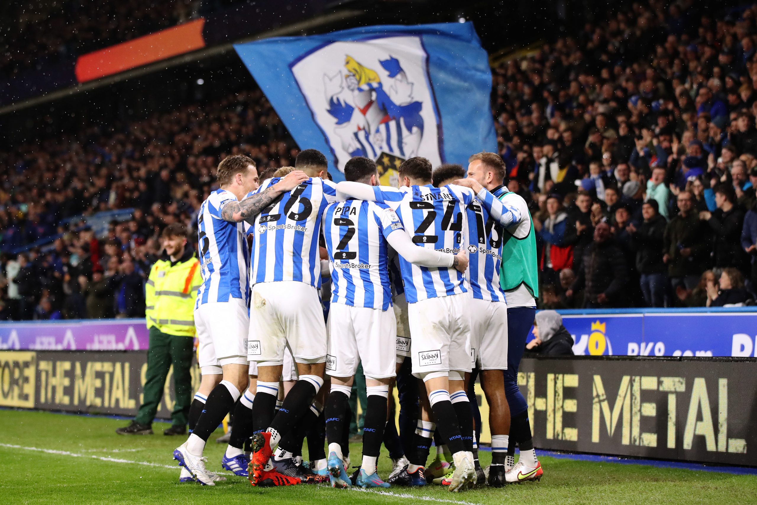 Jon Russell of Huddersfield Town celebrates with team mates after scoring their sides first goal du...
