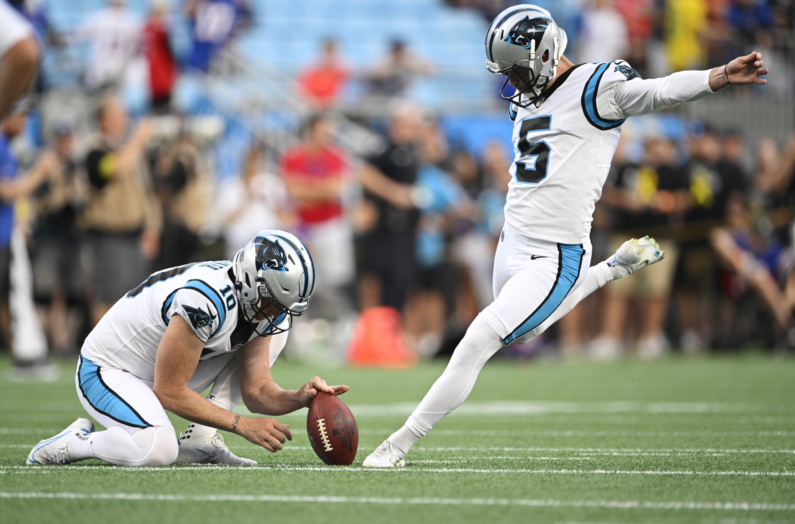 Johnny Hekker #10 of the Carolina Panthers holds the ball for Zane Gonzalez #5 before a preseason g...