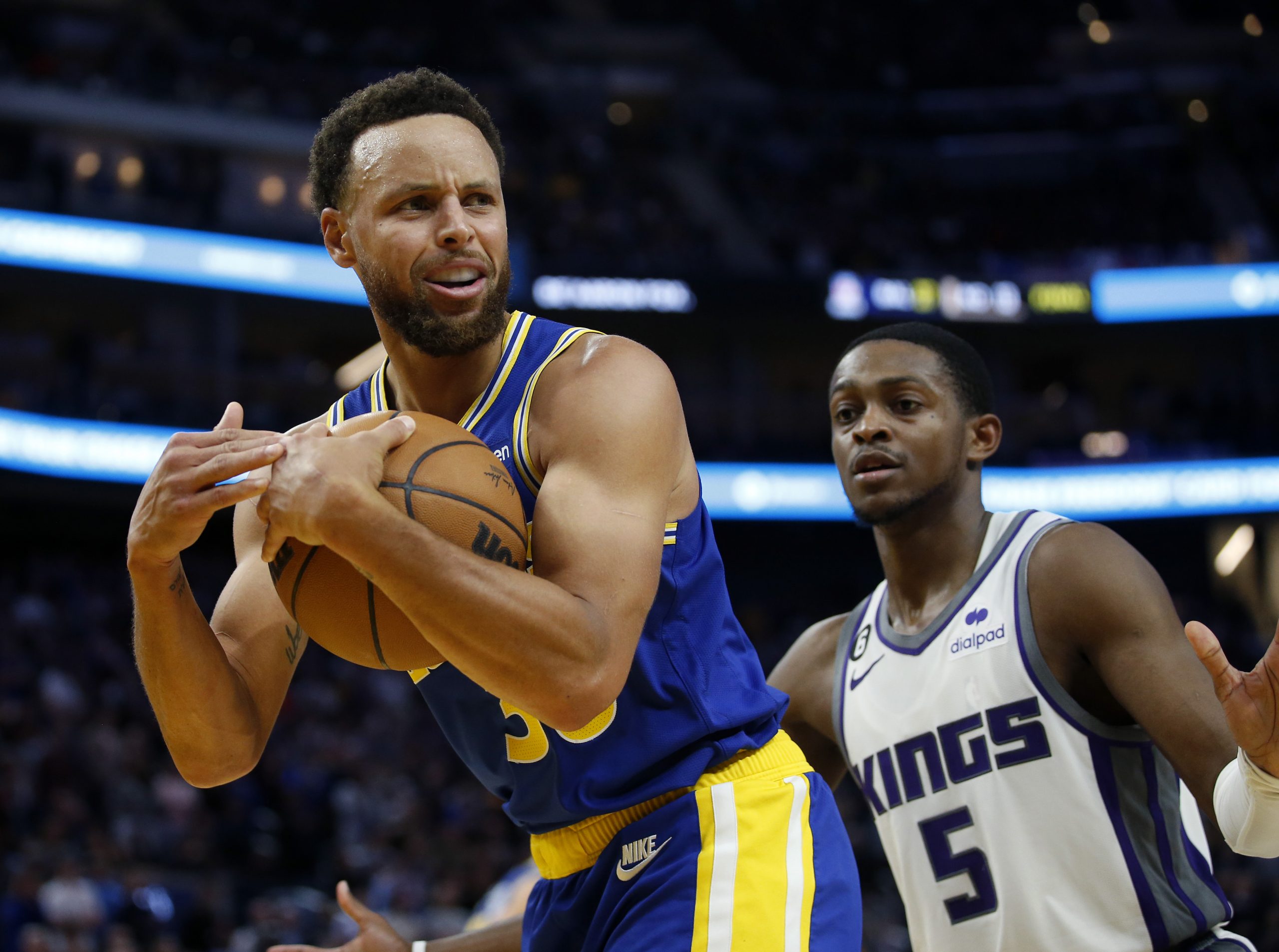 Sacramento Kings guard De'Aaron Fox covers Golden State Warriors' Stephen Curry as he calls a timeo...