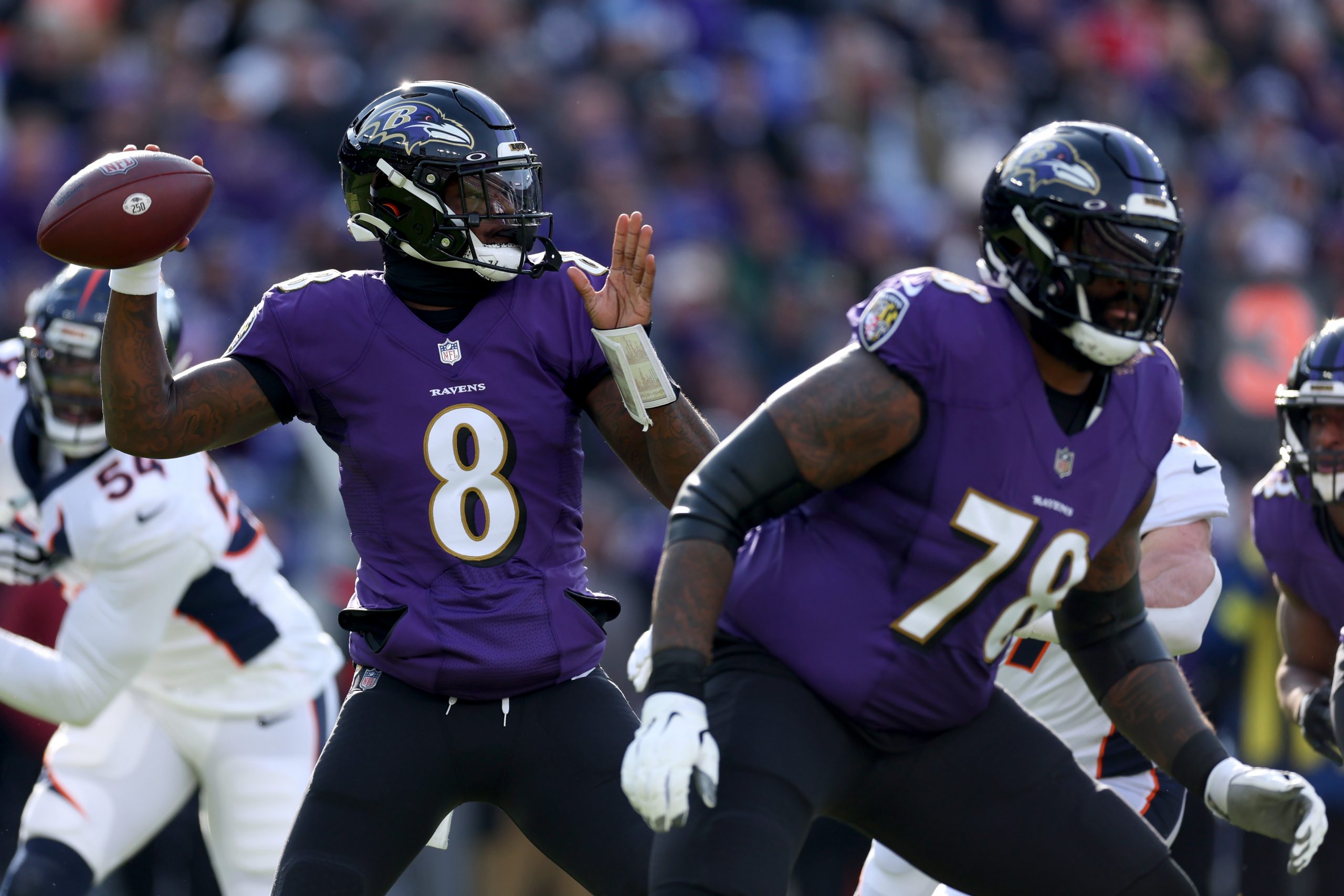Quarterback Lamar Jackson #8 of the Baltimore Ravens drops back to pass against the Denver Broncos ...