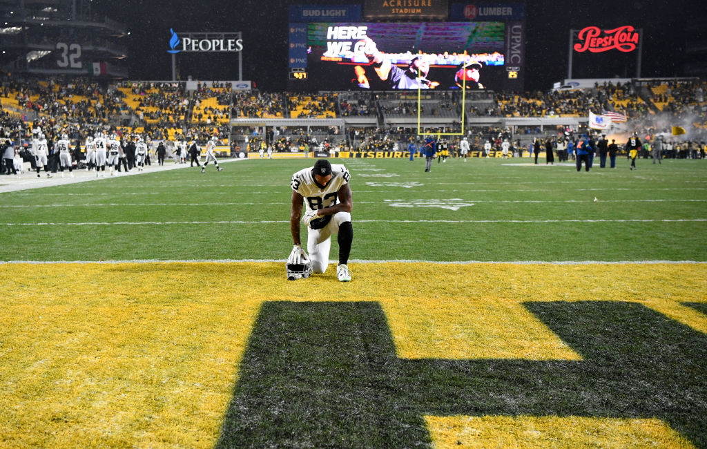 Darren Waller #83 of the Las Vegas Raiders kneels on the field after their loss to the Pittsburgh S...