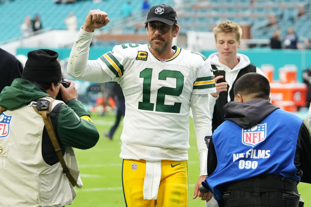 Aaron Rodgers #12 of the Green Bay Packers walks off the field after defeating the Miami Dolphins a...
