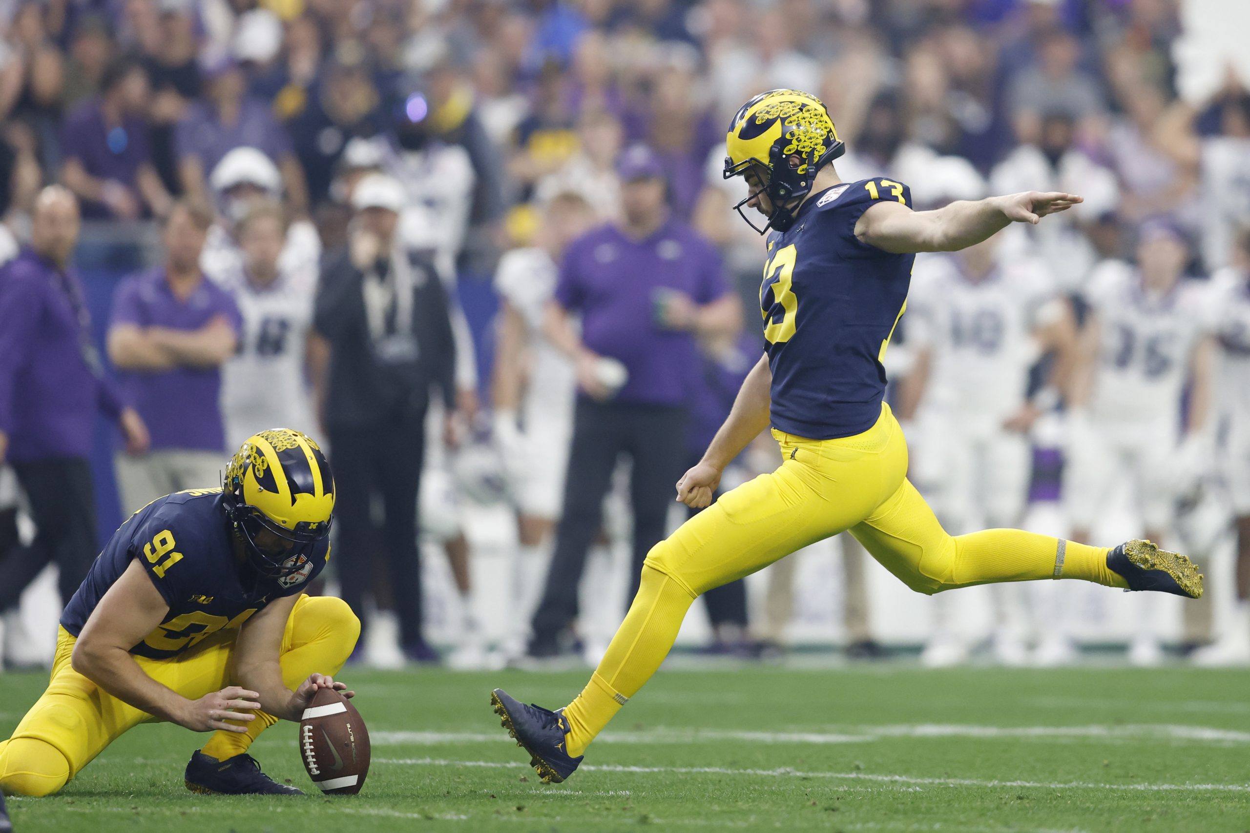 49ers Jake Moody #13 of the Michigan Wolverines kicks a field goal during the second quarter agains...