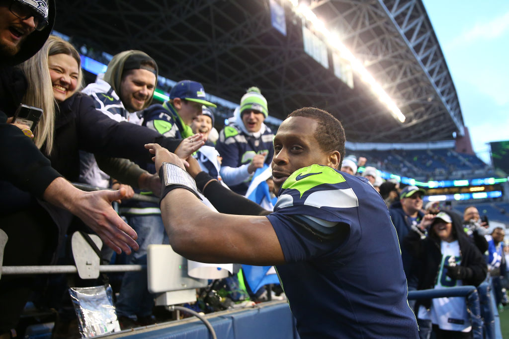 Geno Smith #7 of the Seattle Seahawks celebrates with fans after a win over the New York Jets at Lu...