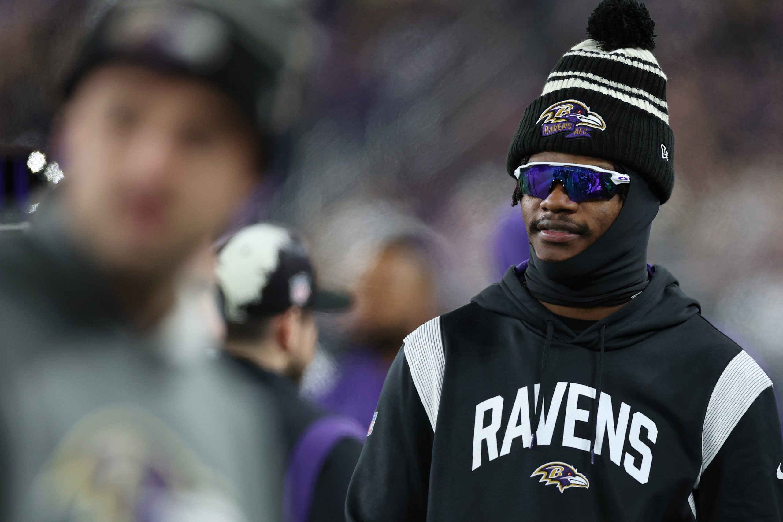 Quarterback Lamar Jackson #8 of the Baltimore Ravens looks on from the sideline as the Baltimore Ra...