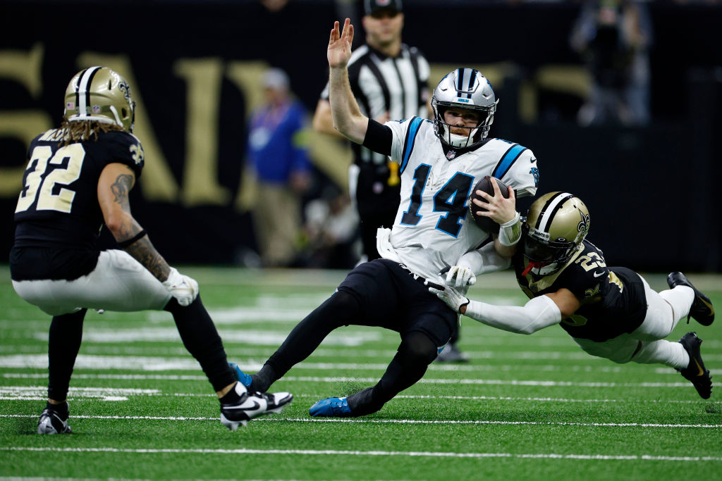 Sam Darnold #14 of the Carolina Panthers is tackled by Marshon Lattimore #23 of the New Orleans Sai...