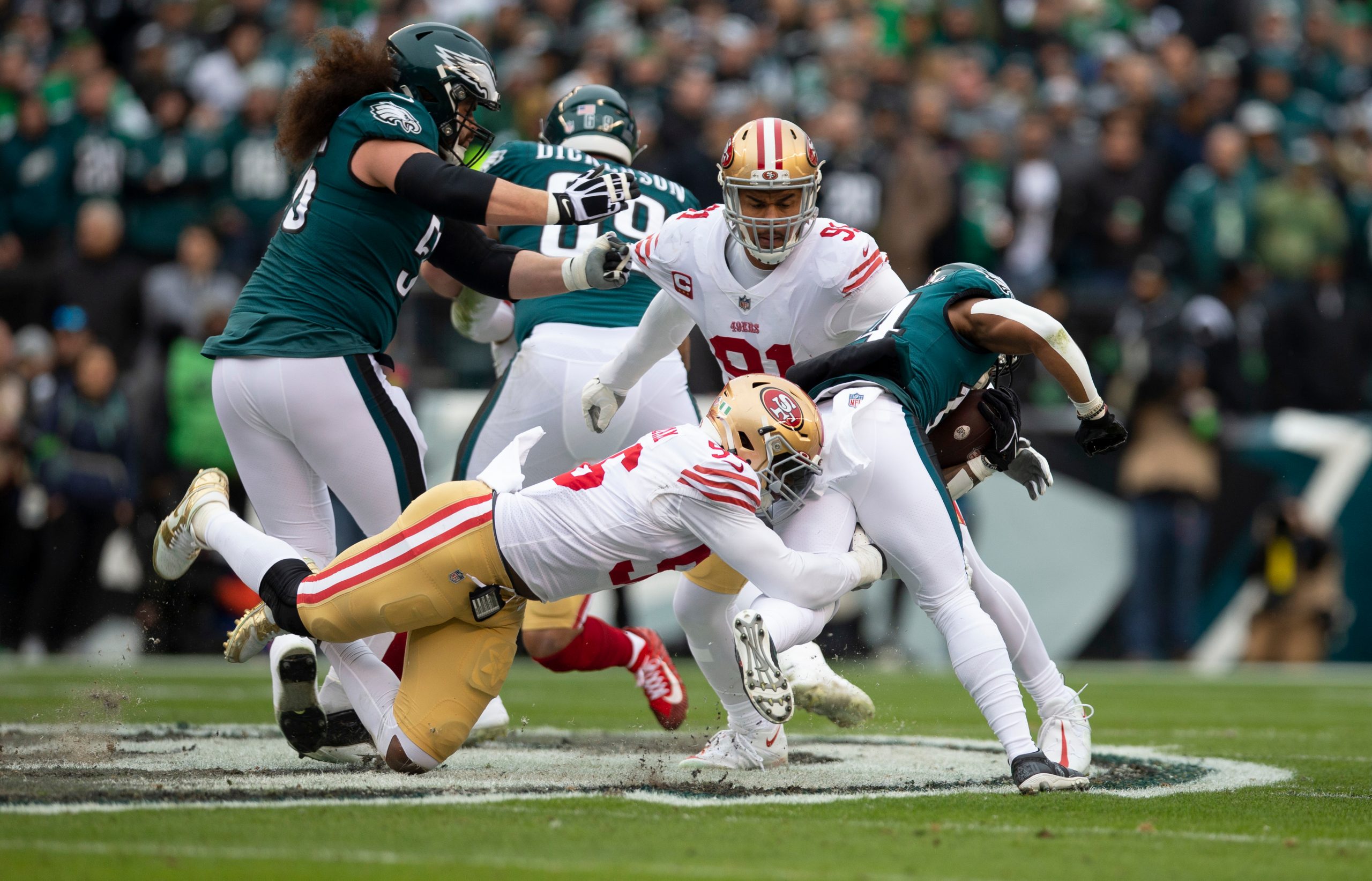 T.Y. McGill #96 and Arik Armstead #91 of the San Francisco 49ers make a tackle during the NFC Champ...