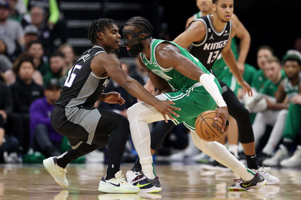 Jaylen Brown #7 of the Boston Celtics is guarded by Davion Mitchell #15 of the Sacramento Kings at ...