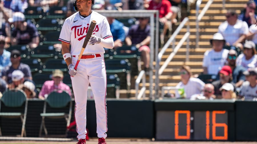 Trevor Larnach #9 of the Minnesota Twins looks on in front of the pitch clock during a spring training game against the Atlanta Braves on March 25, 2023 at Hammond Stadium in Fort Myers, Florida.
