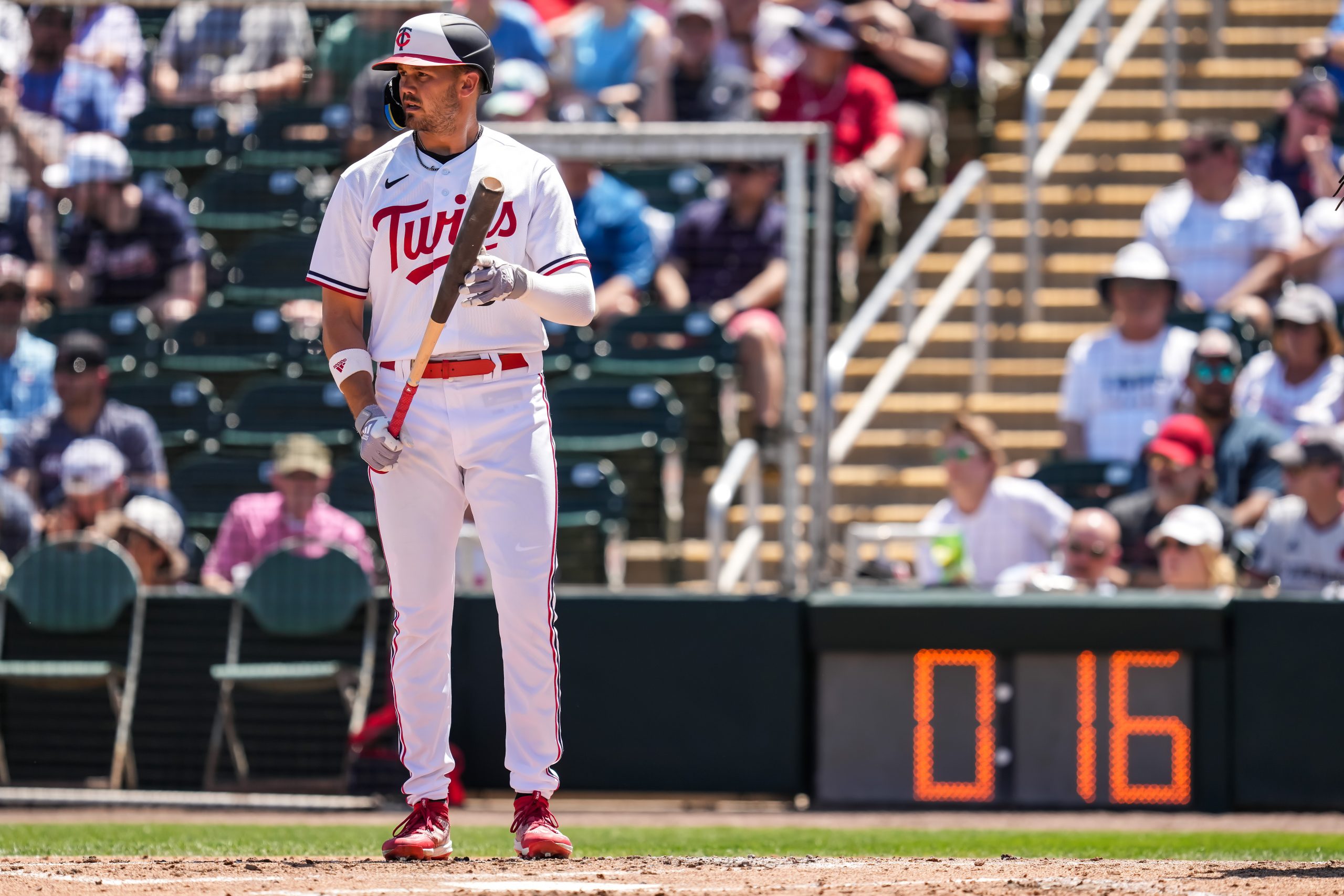 Trevor Larnach #9 of the Minnesota Twins looks on in front of the pitch clock during a spring train...