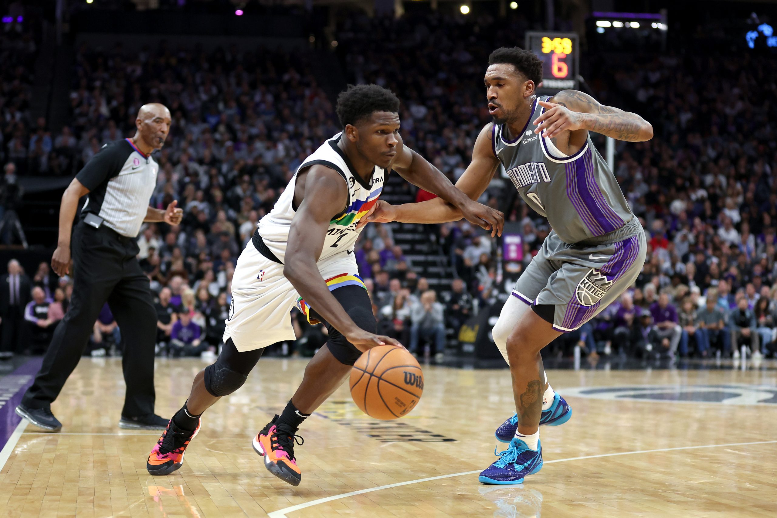 Anthony Edwards #1 of the Minnesota Timberwolves is guarded by Malik Monk #0 of the Sacramento King...