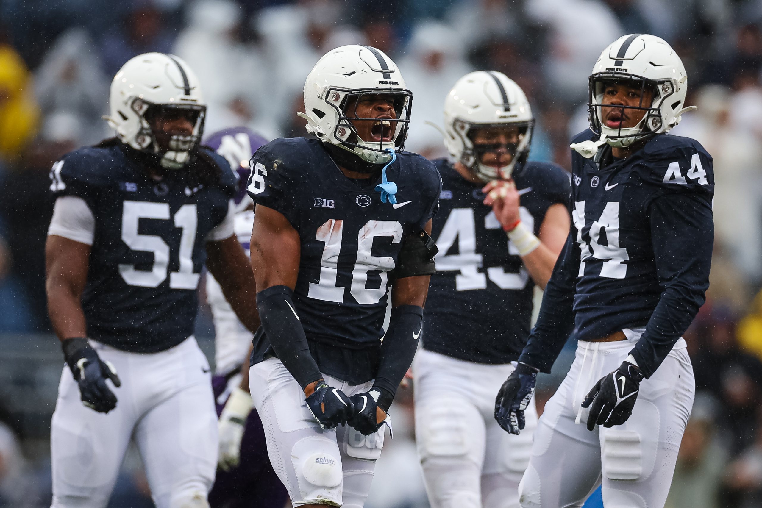 Ji'Ayir Brown #16 of the Penn State Nittany Lions celebrates with teammates after intercepting a pa...