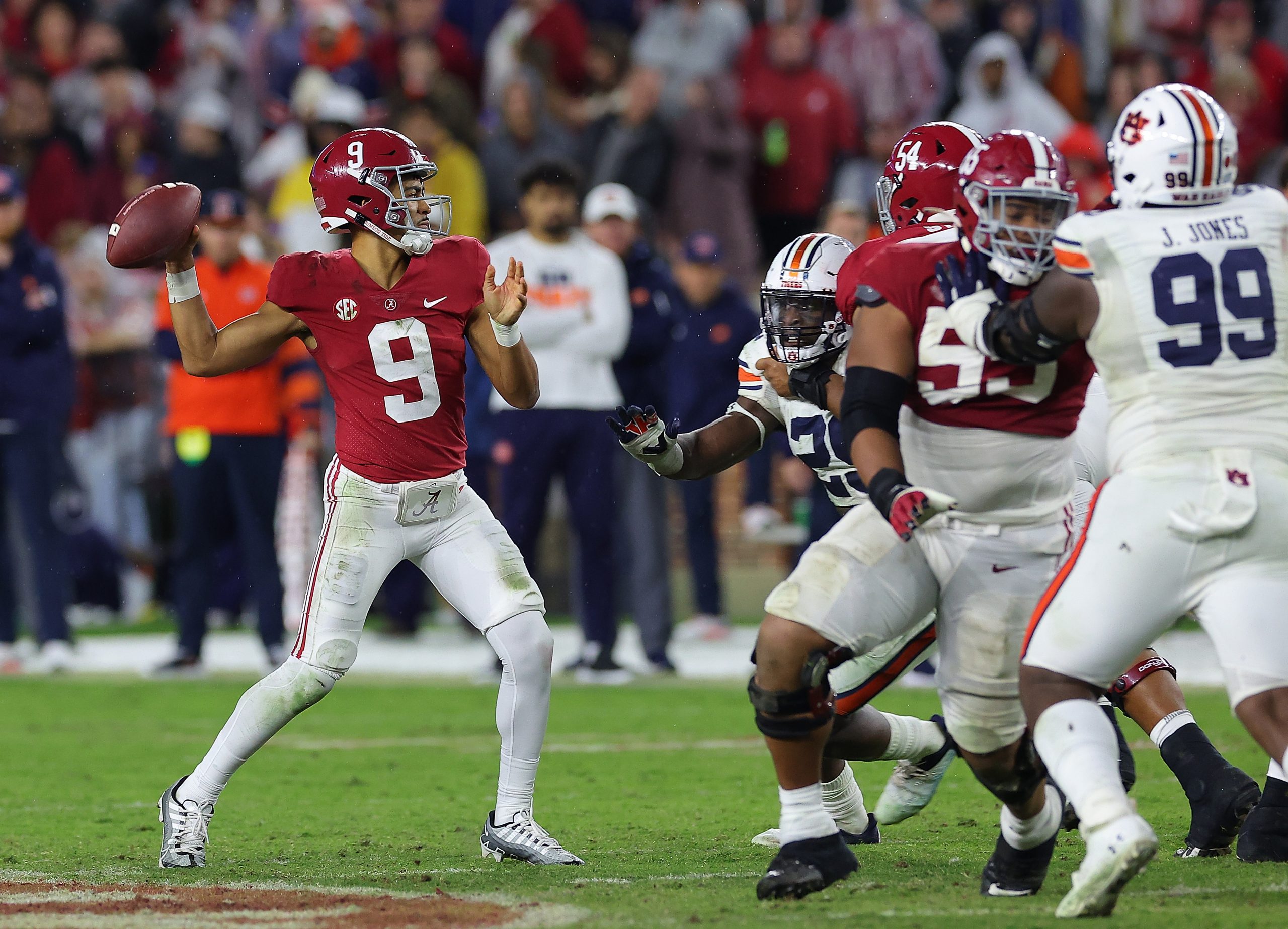Bryce Young #9 of the Alabama Crimson Tide looks to pass against the Auburn Tigers during the secon...