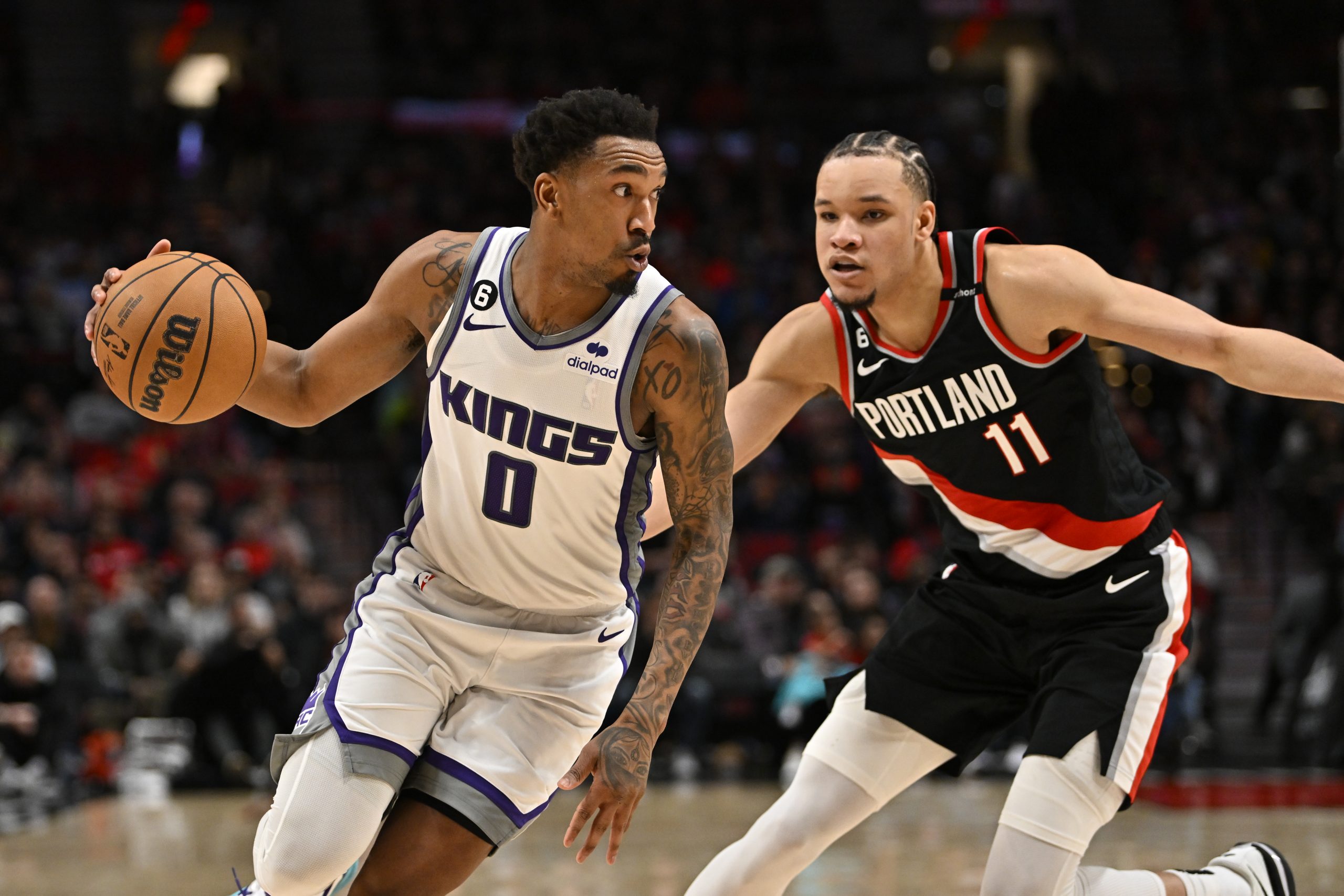 Malik Monk #0 of the Sacramento Kings and Kevin Knox II #11 of the Portland Trail Blazers in action...