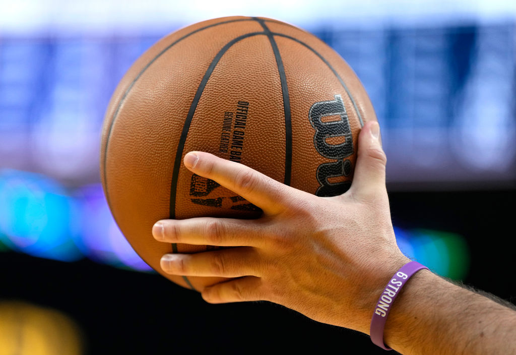 A detailed view of an official Wilson NBA basketball held by a referee during a game between the Sa...