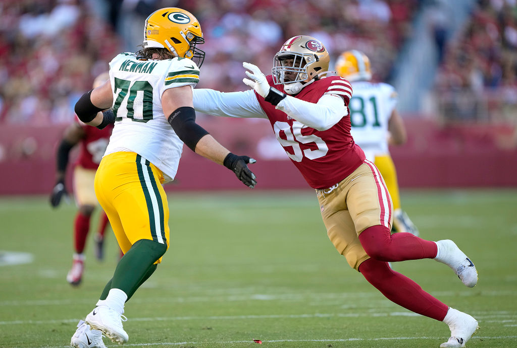 Drake Jackson #95 of the San Francisco 49ers rushes up against Royce Newman #70 of the Green Bay Pa...
