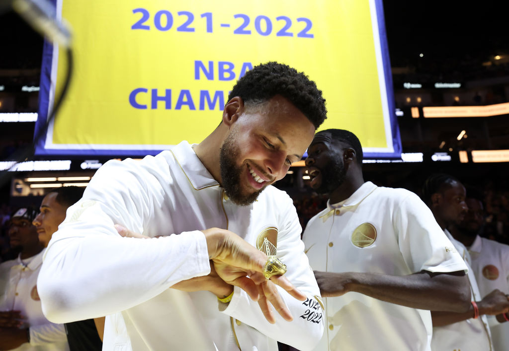 Stephen Curry #30 of the Golden State Warriors inspects his championship ring during a ceremony pri...