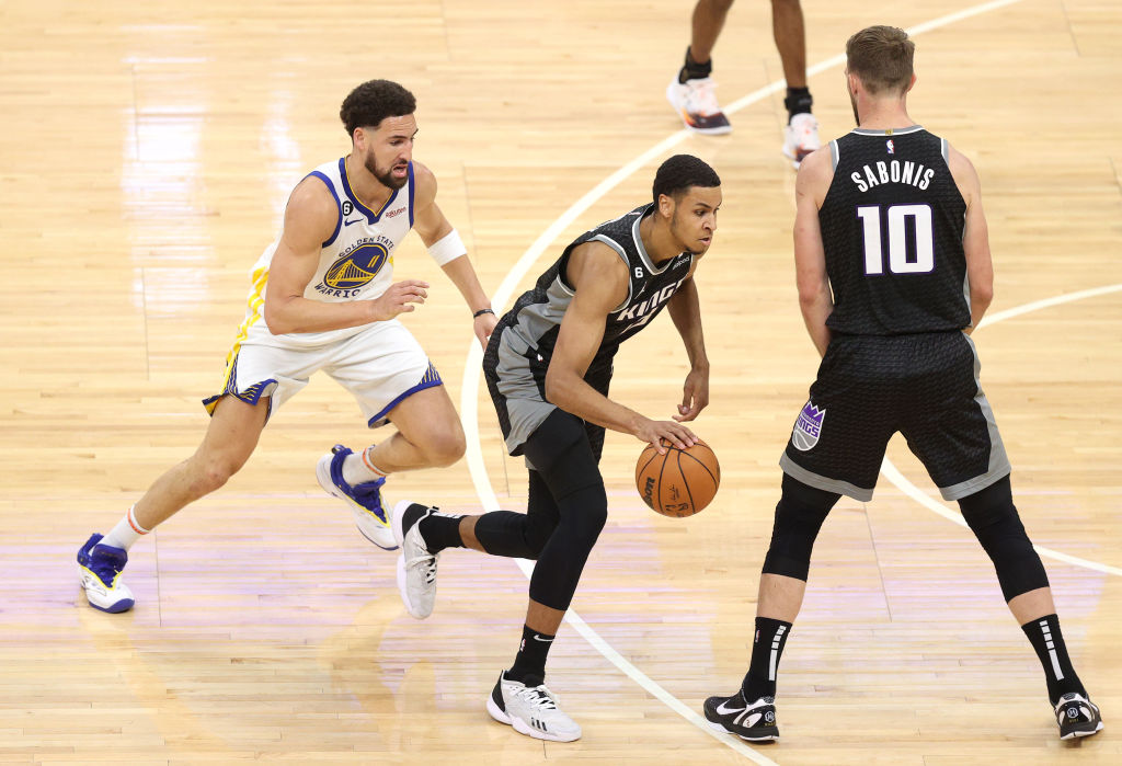 Keegan Murray #13 of the Sacramento Kings dribbles against Klay Thompson #11 of the Golden State Wa...