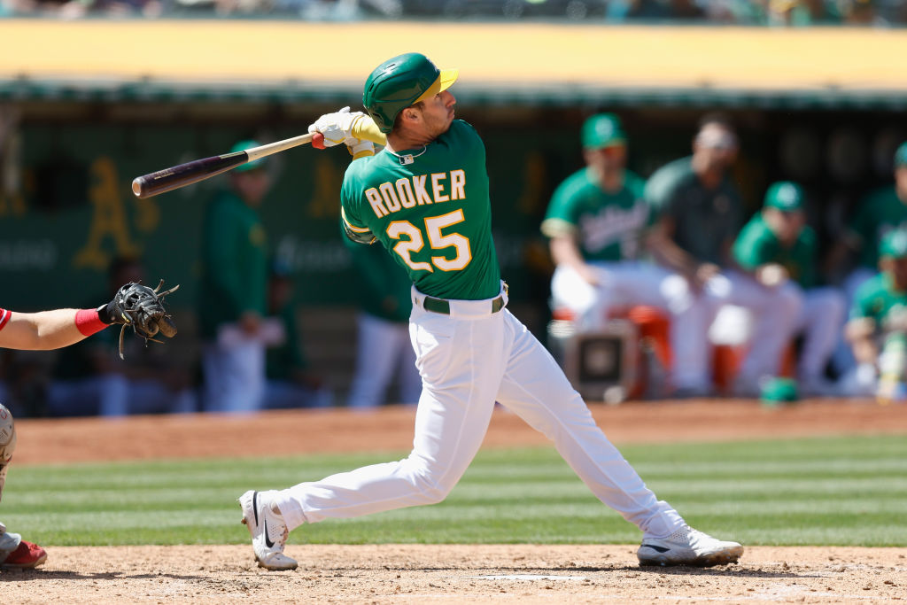 Brent Rooker #25 of the Oakland Athletics hits an RBI sacrifice fly ball in the bottom of the seven...