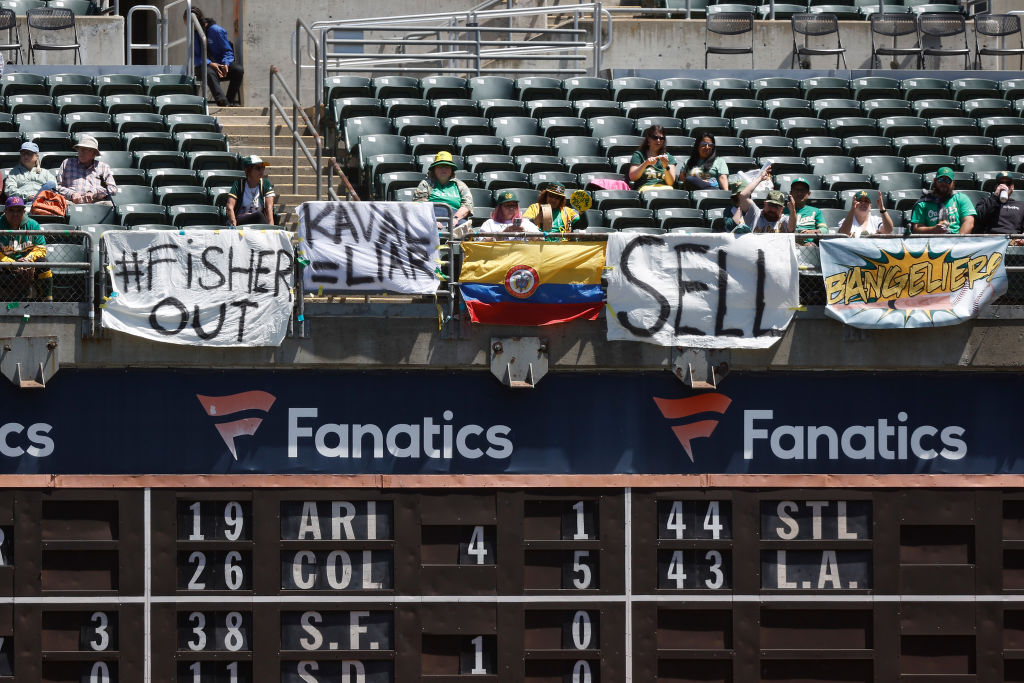 Oakland Athletics fans display signs during the game against the Cincinnati Reds at RingCentral Col...