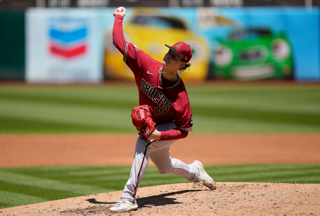 Ryne Nelson #19 of the Arizona Diamondbacks pitches against the Oakland A's in the bottom of the se...