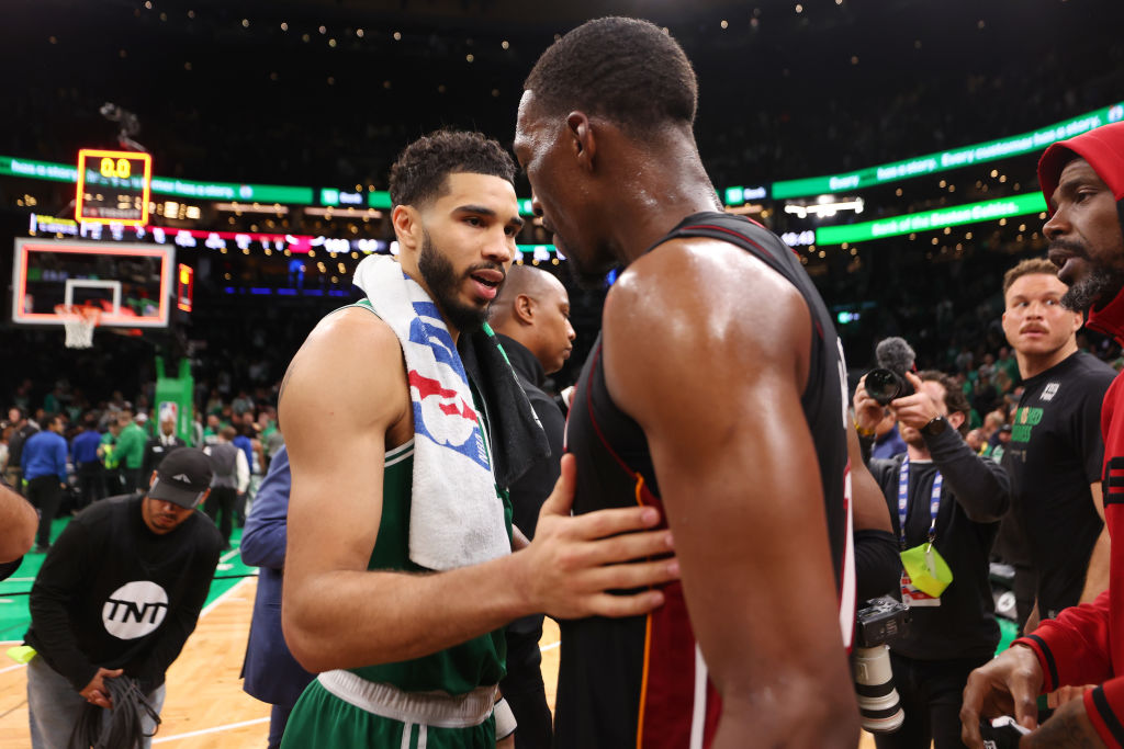 Jayson Tatum #0 of the Boston Celtics greets Bam Adebayo #13 of the Miami Heat after the Heat defea...