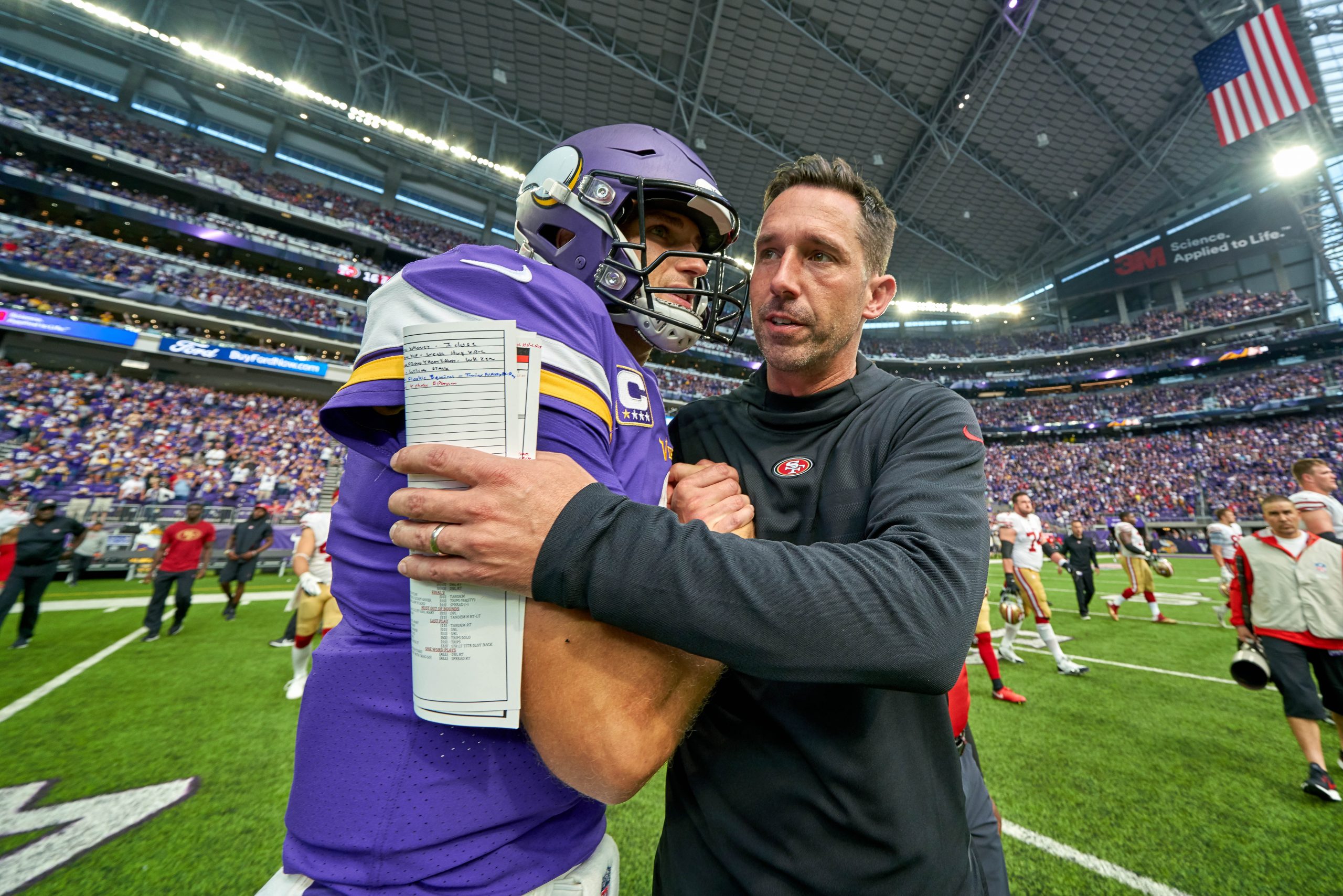 San Francisco 49ers head coach Kyle Shanahan congratulates Minnesota Vikings Quarterback Kirk Cousi...