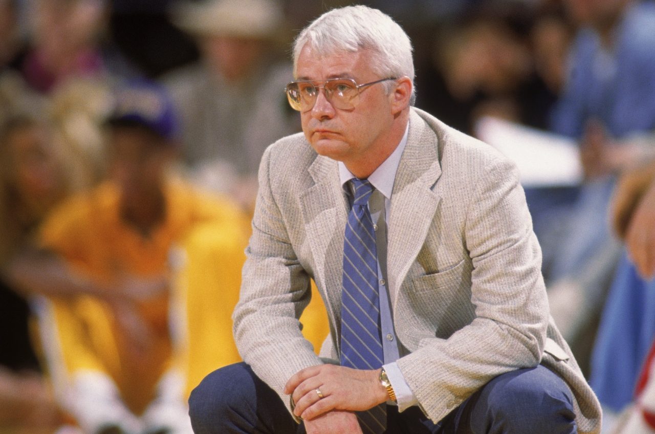 Head coach Jerry Reynolds of the Sacramento Kings crouches on the sideline during an NBA game at Ar...