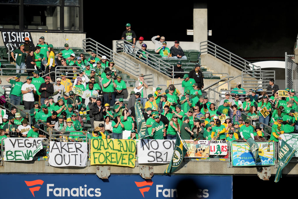 OAKLAND, CALIFORNIA - JUNE 13: Oakland Athletics fans display signs during a reverse boycott game a...