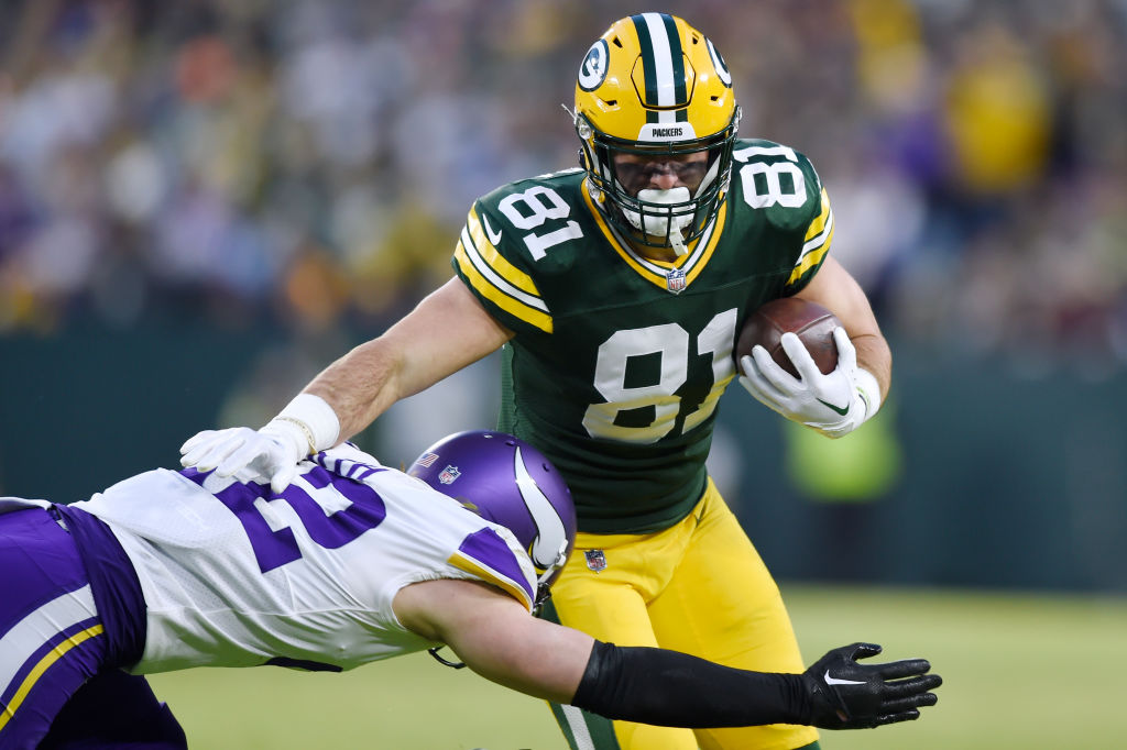 Josiah Deguara #81 of the Green Bay Packers runs the ball against Harrison Smith #22 of the Minneso...