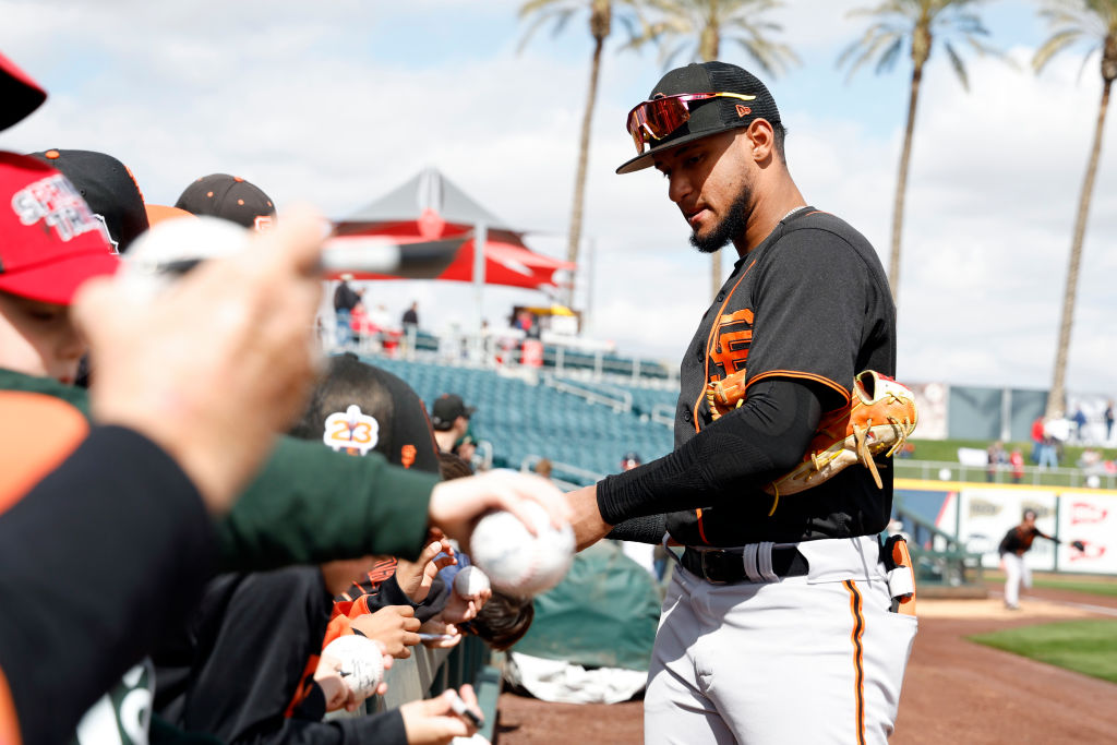 GOODYEAR, ARIZONA - MARCH 02: Luis Matos #78 of the San Francisco Giants signs autographs before th...