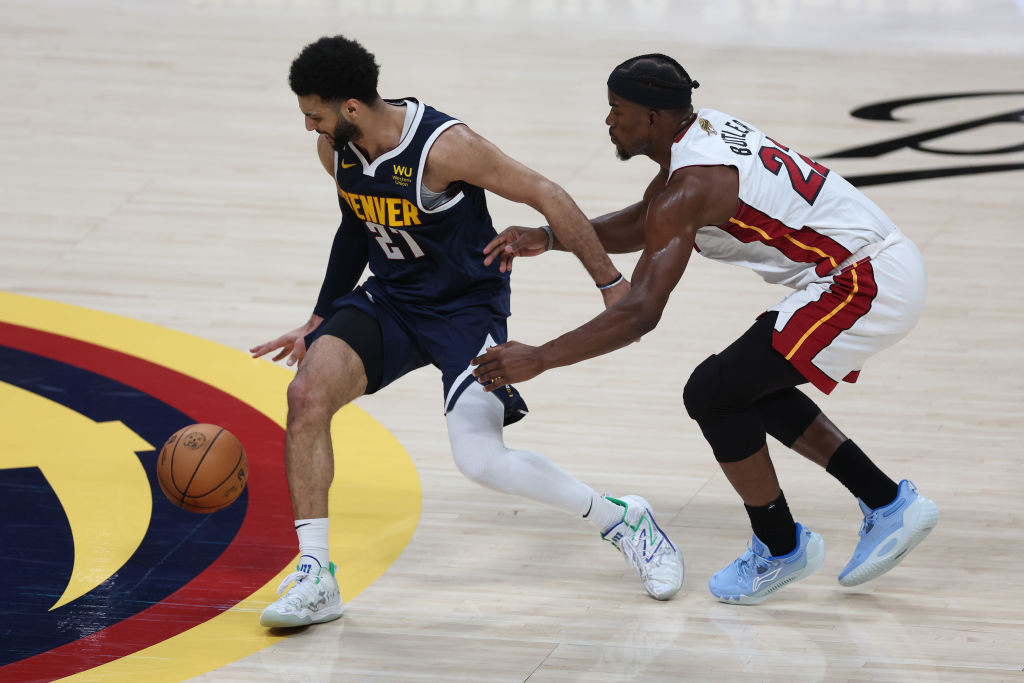 Jamal Murray #27 of the Denver Nuggets dribbles against Jimmy Butler #22 of the Miami Heat during t...