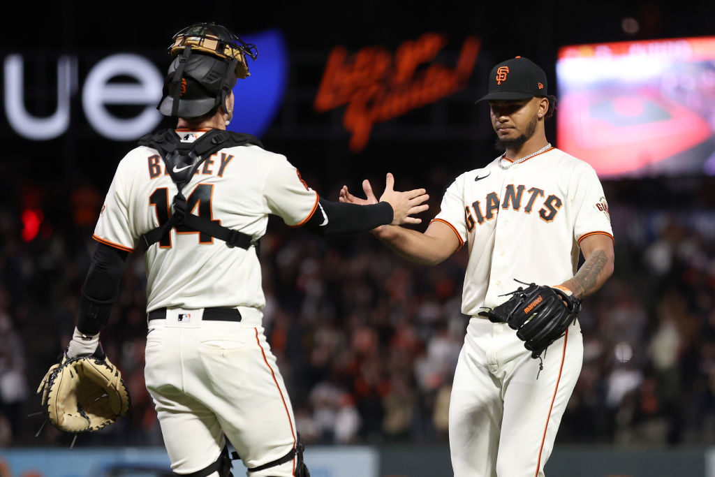 Camilo Doval #75 of the San Francisco Giants is congratulated by Patrick Bailey #14 after they beat...