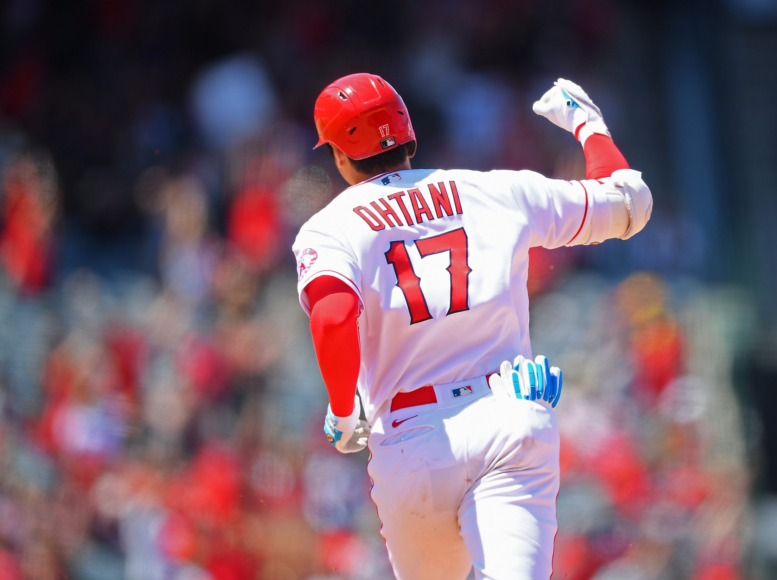 Shohei Ohtani #17 of the Los Angeles Angels pumps his fist as he rounds the bases after hitting a t...
