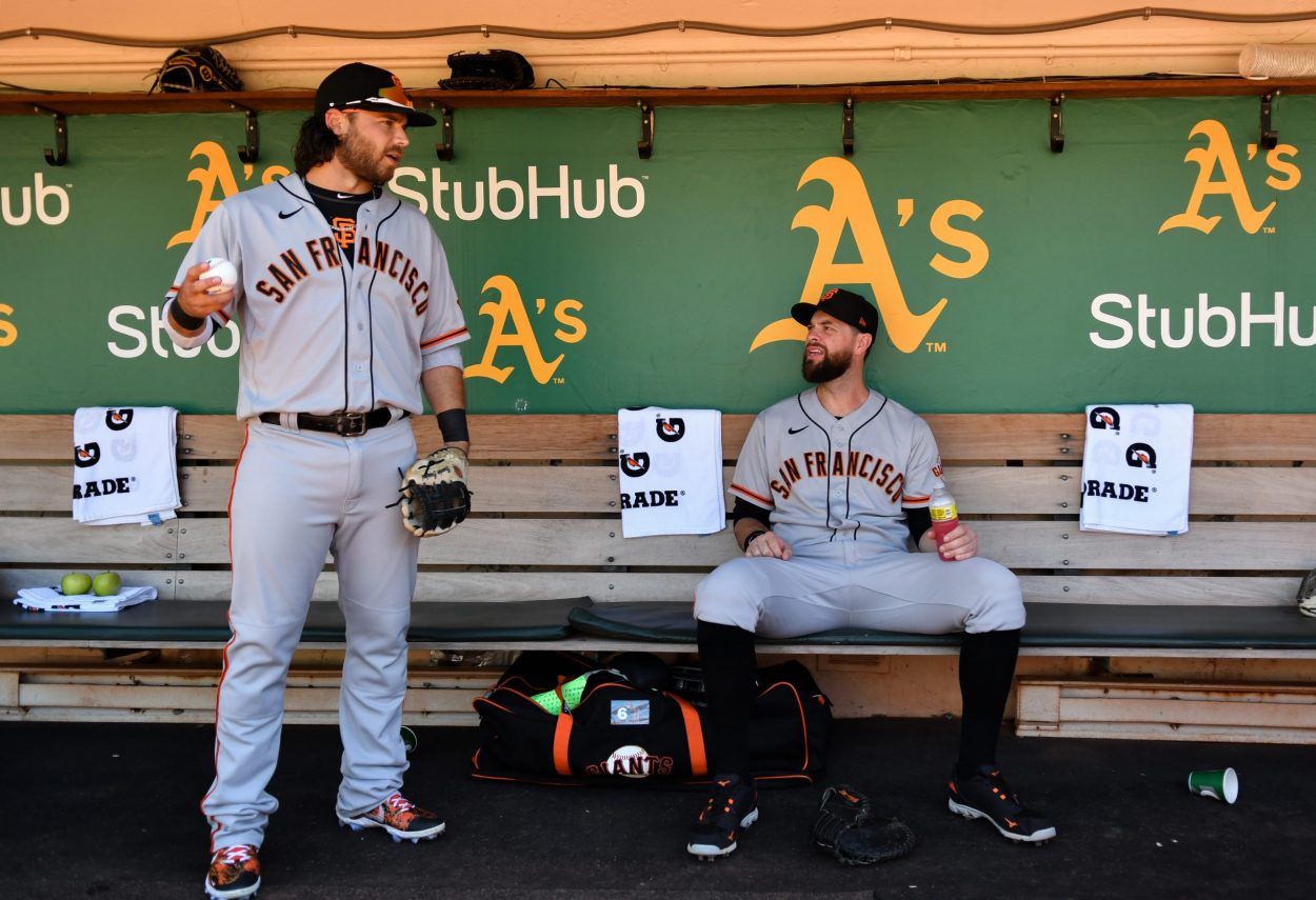 Brandon Crawford #35 of the San Francisco Giants speaks to (R) Brandon Belt #9 before a game agains...