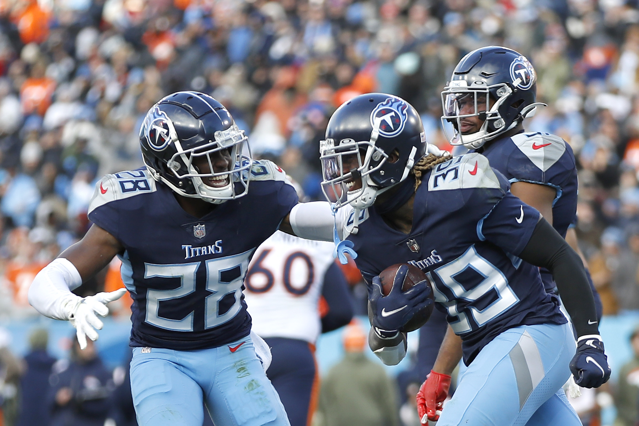 Joshua Kalu #28 of the Tennessee Titans celebrates with Terrance Mitchell #39 of the Tennessee Tita...