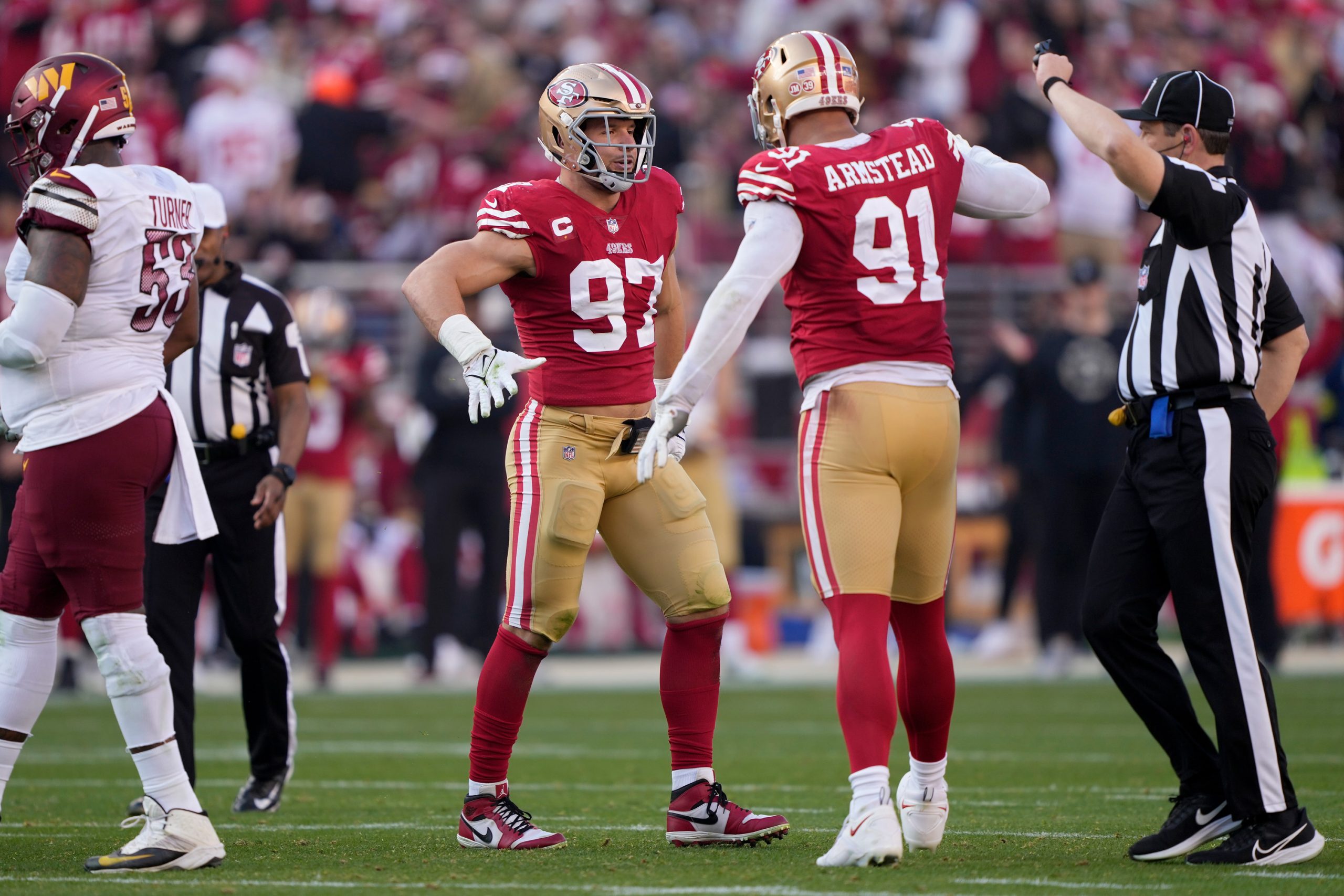 Nick Bosa #97 and Arik Armstead #91 of the San Francisco 49ers celebrate a play during the first ha...