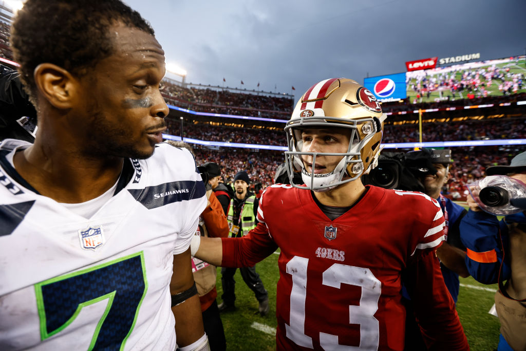 Brock Purdy #13 of the San Francisco 49ers and Geno Smith #7 of the Seattle Seahawks meet following...