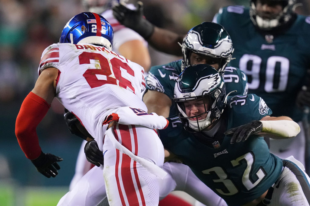 Reed Blankenship #32 of the Philadelphia Eagles tackles Saquon Barkley #26 of the New York Giants d...